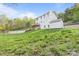Exterior view of backyard with pool and large yard, storage shed, and forest at 380 Hamrick Rd # 1, Gastonia, NC 28056
