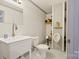 Compact basement bathroom featuring a toilet, urinal, and sink at 380 Hamrick Rd # 1, Gastonia, NC 28056