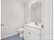 Small bathroom showcasing a toilet, vanity with sink, and a door perfect for convenience at 380 Hamrick Rd # 1, Gastonia, NC 28056
