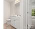 Compact bathroom featuring a white toilet, vanity with sink, and open doorway leading to a carpeted room at 380 Hamrick Rd # 1, Gastonia, NC 28056