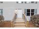 Front door with small porch, steps, gray siding, shutters, and a trimmed yard at 380 Hamrick Rd # 1, Gastonia, NC 28056