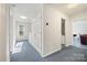 Upstairs hallway with blue carpet leading to a bathroom and rooms, offering multiple access points at 380 Hamrick Rd # 1, Gastonia, NC 28056