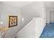 Bright stairway with blue carpet and tiger picture on wall that leads up to the second story of the home at 380 Hamrick Rd # 1, Gastonia, NC 28056