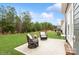 Backyard patio with two chairs perfect for outdoor relaxation overlooking green space at 4024 Whipcord Dr, Waxhaw, NC 28173