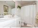 Bright bathroom with double vanity, framed mirror, and decorative plant adding a touch of nature at 4024 Whipcord Dr, Waxhaw, NC 28173