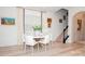 Bright dining room with a white table, modern chairs, and natural light, complemented by tasteful decor and a staircase view at 4024 Whipcord Dr, Waxhaw, NC 28173