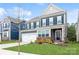 Charming two-story home with a well-maintained lawn, a two car garage and beautiful landscaping at 4024 Whipcord Dr, Waxhaw, NC 28173