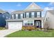Charming two-story home with a well-maintained lawn, a two car garage and beautiful landscaping at 4024 Whipcord Dr, Waxhaw, NC 28173