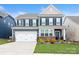 Charming two-story home with a well-maintained lawn, a two car garage and beautiful landscaping at 4024 Whipcord Dr, Waxhaw, NC 28173