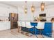 Modern kitchen with white cabinets, stainless steel appliances, and an island with seating at 4024 Whipcord Dr, Waxhaw, NC 28173