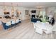 Open floor plan integrates kitchen, dining, and living areas, showcasing modern design with a blue accent wall and white walls at 4024 Whipcord Dr, Waxhaw, NC 28173
