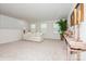 Bright loft space featuring neutral carpet, a comfy sofa, a decorative table, and natural light at 4024 Whipcord Dr, Waxhaw, NC 28173