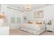 Serene primary bedroom with a large window, modern lighting, and elegant furnishings for a relaxing retreat at 4024 Whipcord Dr, Waxhaw, NC 28173