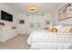 Elegant primary bedroom featuring decorative lighting, a large window, and stylish decor at 4024 Whipcord Dr, Waxhaw, NC 28173