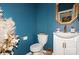 Stylish powder room with blue patterned wallpaper, a decorative mirror and modern fixtures at 4024 Whipcord Dr, Waxhaw, NC 28173
