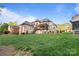 Large backyard showcasing the home's exterior, covered patio, and expansive lawn at 4025 Foxes Trl, Cramerton, NC 28032