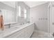 Modern bathroom featuring double sinks, white cabinets, marble countertops, and sleek lighting fixtures at 4025 Foxes Trl, Cramerton, NC 28032