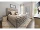 Neutral bedroom featuring a tufted headboard, plush rug, and natural light at 4025 Foxes Trl, Cramerton, NC 28032