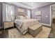 Stylish bedroom with a luxurious bed, decorative pillows, and soft lighting at 4025 Foxes Trl, Cramerton, NC 28032
