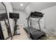 Home gym area with a treadmill, stationary bike, and laundry area at 4025 Foxes Trl, Cramerton, NC 28032