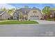 Charming brick and stone home with a well-manicured lawn and attached two-car garage at 4025 Foxes Trl, Cramerton, NC 28032