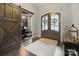 Inviting foyer with rich hardwood floors, a decorative rug and striking glass front doors at 4025 Foxes Trl, Cramerton, NC 28032