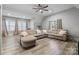 Spacious living room featuring a large sectional sofa, wood floors, and natural light at 4025 Foxes Trl, Cramerton, NC 28032