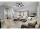 Inviting living area with a comfortable sectional sofa, ceiling fan, and neutral décor at 4025 Foxes Trl, Cramerton, NC 28032