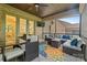 Covered patio featuring outdoor seating and dining areas with a ceiling fan and TV at 4025 Foxes Trl, Cramerton, NC 28032
