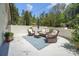 Charming backyard patio featuring wicker furniture, an umbrella and a whitewashed brick wall at 4205 Cahnnas Way, Waxhaw, NC 28173