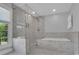 Bright bathroom featuring a glass enclosed shower and a luxurious soaking tub at 4205 Cahnnas Way, Waxhaw, NC 28173