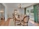 Elegant dining room with hardwood floors, large table, and floral patterned curtains at 4205 Cahnnas Way, Waxhaw, NC 28173