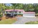 Beautiful white brick home featuring a red roof and a spacious three-car garage at 4205 Cahnnas Way, Waxhaw, NC 28173