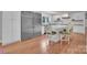 Kitchen featuring large island, stainless refrigerator, modern chairs, and hardwood flooring at 4205 Cahnnas Way, Waxhaw, NC 28173