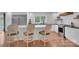 Spacious kitchen showcasing a large island, stainless steel appliances, white cabinets, and light hardwood floors at 4205 Cahnnas Way, Waxhaw, NC 28173