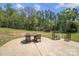 Outdoor patio area featuring stamped concrete, table with four chairs, and umbrella, perfect for entertaining at 4205 Cahnnas Way, Waxhaw, NC 28173
