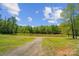 Picturesque view of a pond surrounded by lush greenery, showcasing the property's natural beauty at 4205 Cahnnas Way, Waxhaw, NC 28173