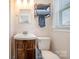 Bright bathroom featuring a single vanity, updated mirror, toilet and towel rack at 424 Mirror Lake Rd, Salisbury, NC 28146