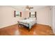 Bedroom features a ceiling fan, windows with wood shutters, and hardwood floors at 424 Mirror Lake Rd, Salisbury, NC 28146