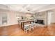 Bright dining room with beamed ceilings, stylish lighting, fireplace and modern seating area at 424 Mirror Lake Rd, Salisbury, NC 28146