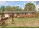Ranch style brick home with green shutters, nicely landscaped yard and a detached garage at 424 Mirror Lake Rd, Salisbury, NC 28146