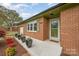 Inviting front porch with red brick, decorative plants and a 'home sweet home' welcome mat at 424 Mirror Lake Rd, Salisbury, NC 28146