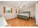 Cozy main bedroom features a ceiling fan, windows with wood shutters, and light-colored walls at 424 Mirror Lake Rd, Salisbury, NC 28146