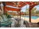 Outdoor patio with seating area, pergola, ceiling fan, and view of the swimming pool at 424 Mirror Lake Rd, Salisbury, NC 28146