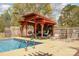 Backyard inground pool with a wooden pergola, comfortable seating, and a relaxing ambiance at 424 Mirror Lake Rd, Salisbury, NC 28146