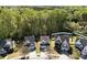 Aerial view of a home nestled among lush trees in a residential community with well maintained landscaping at 428 Winecoff Woods Nw Dr, Concord, NC 28027