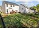 Backyard with lush lawn, minimal landscaping, black metal fence and neighbor home at 428 Winecoff Woods Nw Dr, Concord, NC 28027