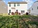 Wide backyard with a lush lawn, minimal landscaping, black metal fence and neighbor home at 428 Winecoff Woods Nw Dr, Concord, NC 28027