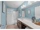 Bright bathroom features a tub and shower, vanity with drawers and a large mirror with vanity lighting at 428 Winecoff Woods Nw Dr, Concord, NC 28027