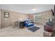Inviting bonus room with carpet, chandelier, and entertainment center by a window at 428 Winecoff Woods Nw Dr, Concord, NC 28027